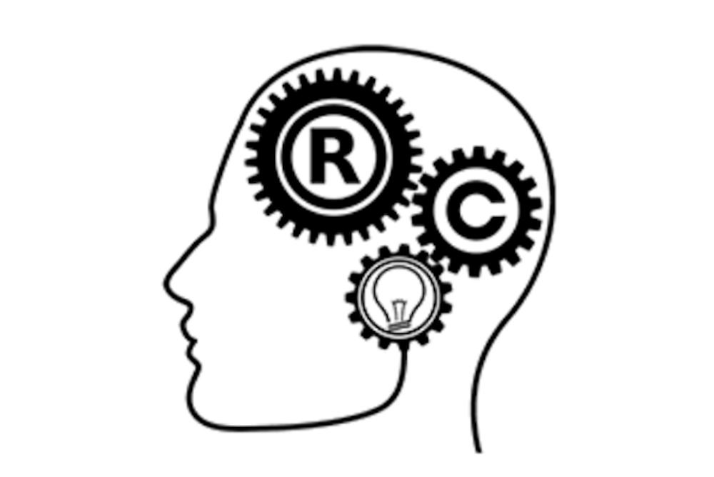 Silhouette drawing of a person's head with trademark and copyright symbols and a lightbulb