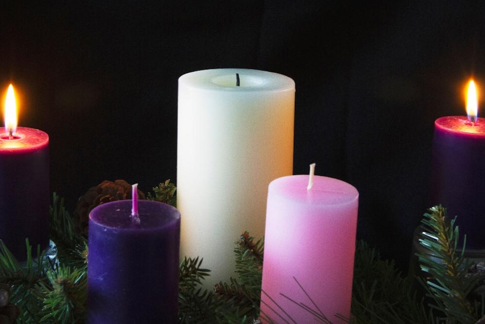 An Advent wreath showing two lit candles for the second week of Advent (which starts on December 10th).