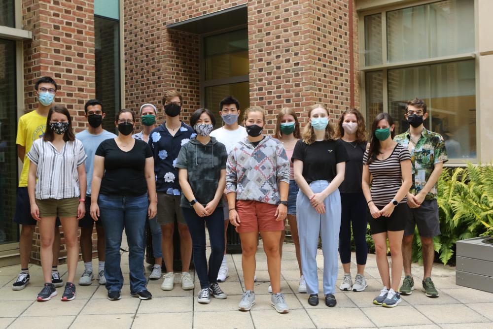 Professor O'Brien and students working in her lab. Photo taken in the ISC courtyard, all persons are masked.