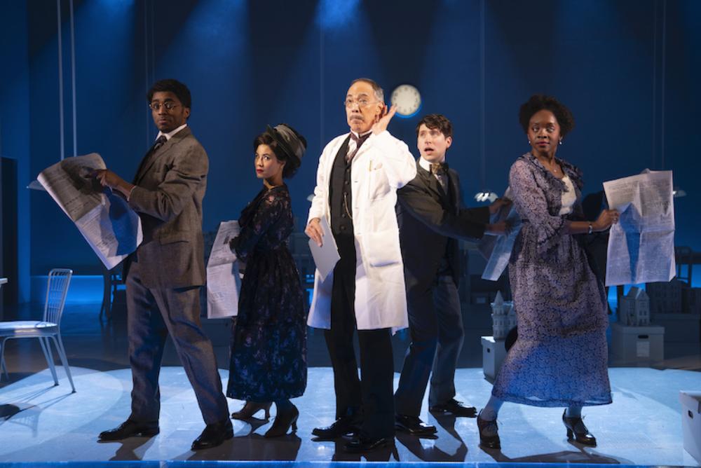 musical cast on stage, 5 individuals, blue lights