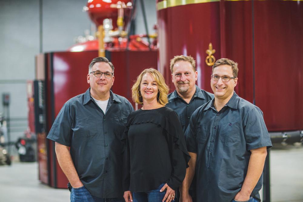 Pictured: Virago Spirits owners, brothers Barry, Barton and Brad Haneberg ’90, P '21, and Vicki Haneberg ’90, P '21.