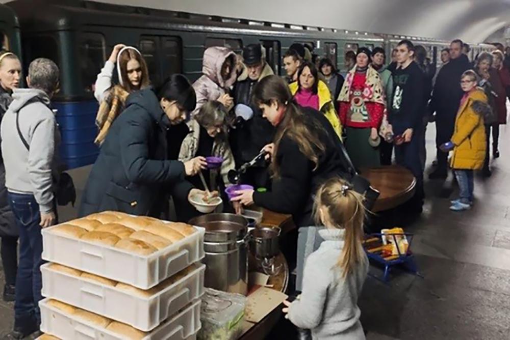People in a subway station serving as a bomb shelter receiving food through a WFP program. Credit: WFP/UN News