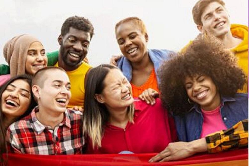 A group of eight youth smiling and laughing.