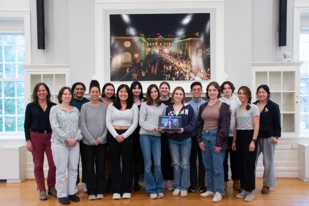 Sharp journalism students and staff standing in front of a picture in Blow Hall