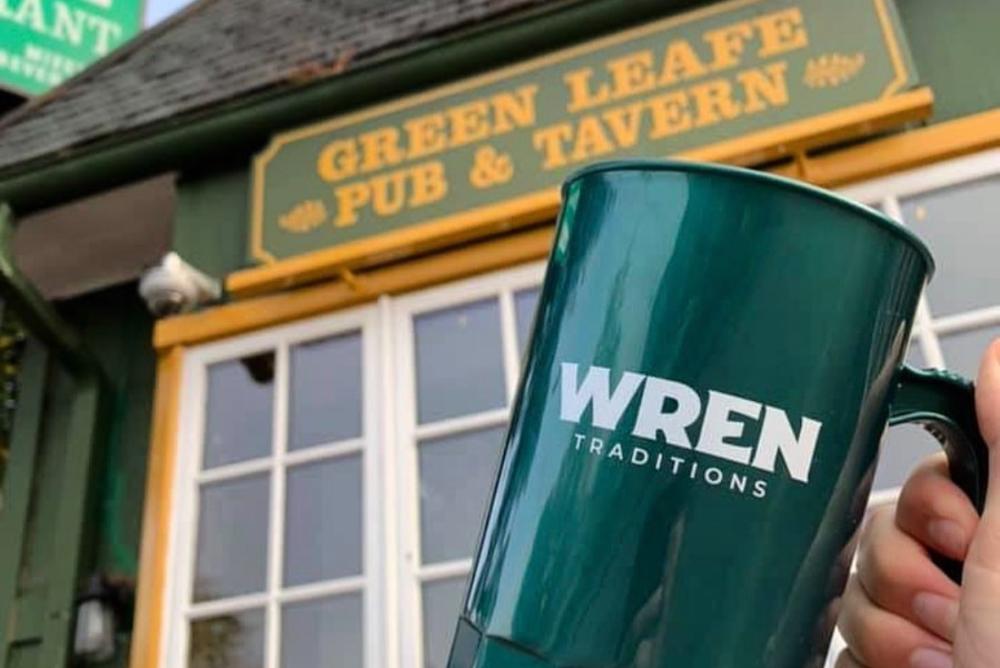 The Senior Class Gift mug is held outside Green Leafe Pub & Tavern