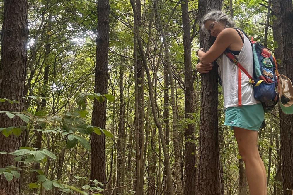 Woman hugging a tree