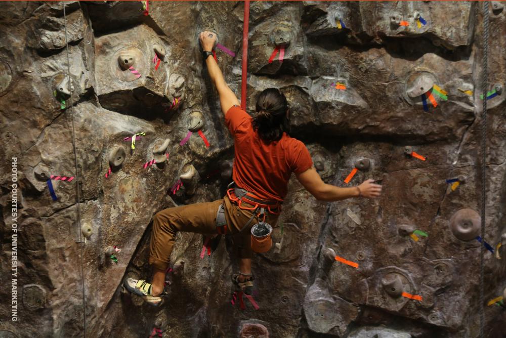 Student climbing at climbing wall