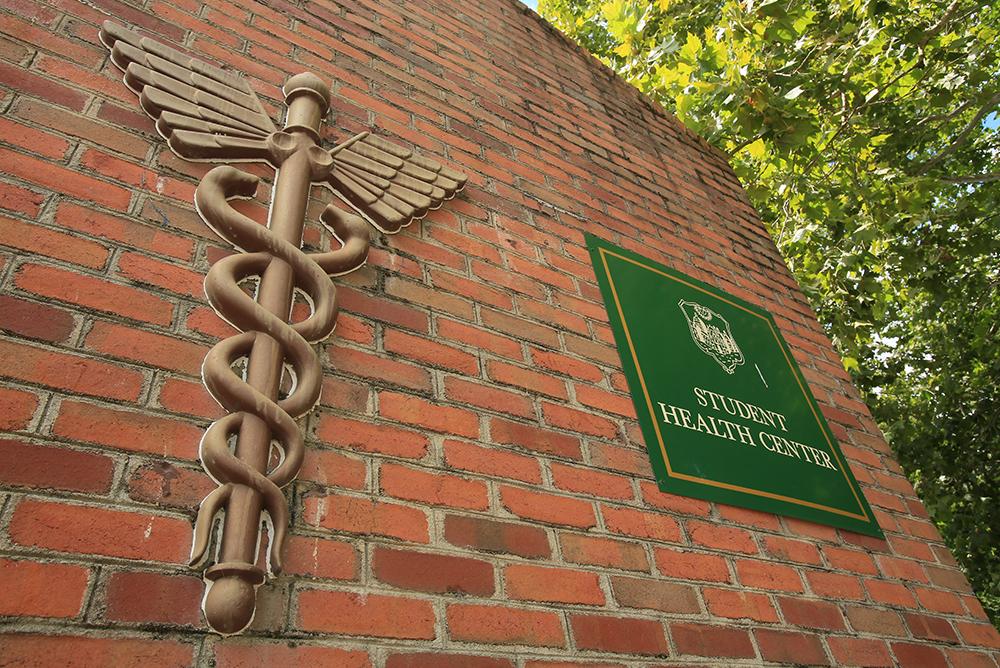 Student Health Center sign on a brick wall